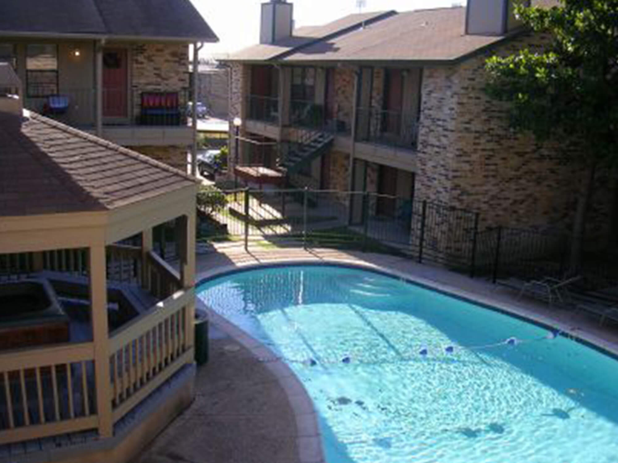 Stadium View Apartments blue community pool and gazebo.