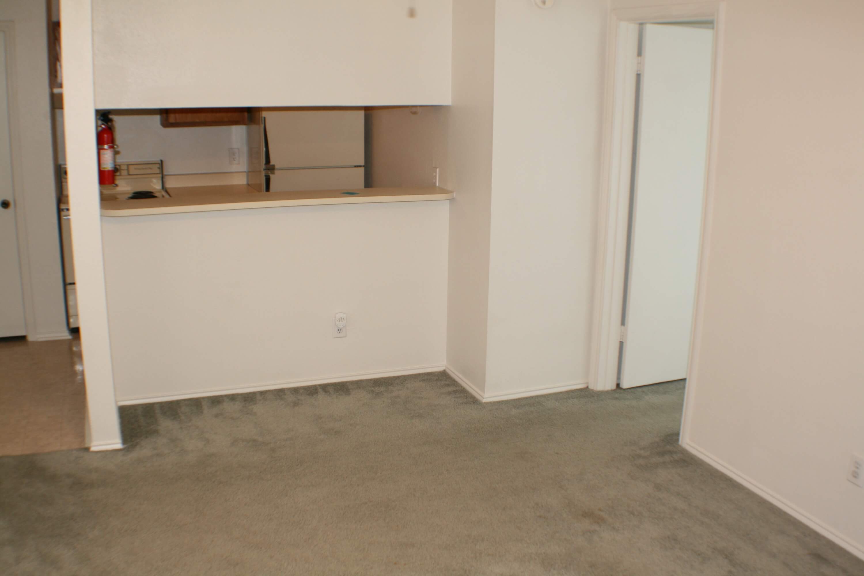 The living room looking into the kitchen at Stadium View Apartments.